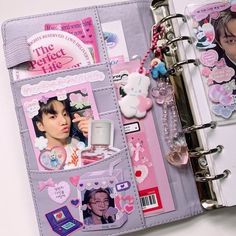 an open planner book with pictures and stickers on it's cover is shown