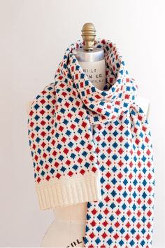 a red, white and blue scarf on a mannequin