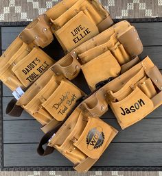 a group of personalized leather bags sitting on top of a wooden table