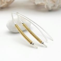 "Silver and Gold Handmade Threader Earrings - Contemporary style! Their sterling silver threader and 14k gold-filled coils add a modern touch making them the perfect choice for any outfit. * Sterling Silver & 14 karat Gold Filled * Approximately 1.5\" long * Sent in a Ribboned Gift Box with Polishing Cloth * Handmade in Montana ----- OUR MATERIALS -----  *STERLING SILVER - Experience the elegance of Sterling Silver, a metal that combines versatility with a sophisticated look. This durable and li Silver Threader Earrings, Mixed Metal Earrings, Open Hoop Earrings, Handmade Modern, Earring Cards, Threader Earrings, Gold Earrings Dangle, Copper Earrings, Metal Earrings