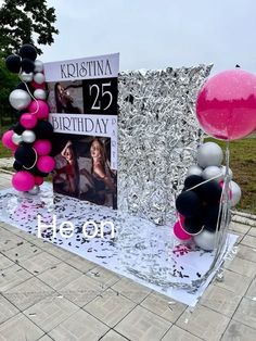 a birthday display with balloons and photos