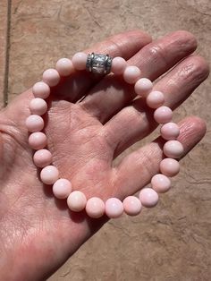 Perfect genuine AAA+ soft pink Peruvian Opal 8mm rounds and a crystal bead to top. Sized at size 7, it will fit smaller wrists and accommodate up to 7 1/2. Pink Faceted Beaded Bracelets, Pink Round Spiritual Beaded Bracelets, Healing Pink Bracelets With Spacer Beads, Elegant Rose Quartz Stretch Bracelet With Round Beads, Spiritual Pink Beaded Hypoallergenic Bracelets, Pink Opal Round Beads Bracelet, Spiritual Pink Round Stretch Bracelet, Pink Stretch Bracelet With Gemstone Beads, Peruvian Opal