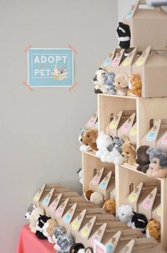 there are many stuffed animals on display in this room with the sign above them that says adopt pet