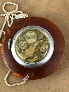 Nurse's Gift Vintage 1950's Imperial Pendant Watch 7 Jewels Brown Simulated Turtle Shell Outer Ring 1 3/4 inch in diameter this is a working Mechanical Hand Wind Watch. Dial is silver/gray with gold hands and a separated second hand has Imperial printed at 12 o'clock the Rear is visible with a clear plastic cover(semi domed bubble watch) Worn by Nurses, Teachers comes with a 24 inch necklace shipping included Antique Polished Pocket Watch, Antique Round Pocket Watch With Polished Finish, Vintage Brown Jewelry With Polished Finish, Handmade Round Bakelite Jewelry, Vintage Polished Pocket Watch As Gift, Vintage Silver Watch Accessories With Polished Finish, Vintage Pocket Watch With Polished Finish As Gift, Vintage Engraved Round Jewelry And Watches, Vintage Round Engraved Jewelry And Watches