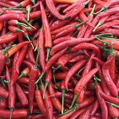 many red peppers are piled up together