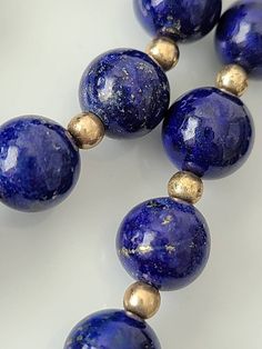 "Cheer up with this genuine blue lapis with gold tone spacer beads. Lapis stones have gold lines and are approx. 8mm. round Clasp: filigree fishhook Length approx. 25\" Condition: Good vintage" Classic Round Lapis Lazuli Jewelry, Lapis Lazuli Round Beaded Necklaces, Lapis Lazuli Necklaces With 8mm Beads, Necklace With 8mm Round Lapis Lazuli Beads, Lapis Lazuli Necklace With 8mm Beads, Elegant Round Lapis Lazuli Beaded Necklaces, Elegant Round Beaded Lapis Lazuli Necklace, Elegant Round Lapis Lazuli Beaded Necklace, Single Strand Lapis Lazuli Round Bead Jewelry