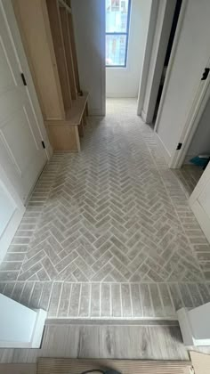 an empty hallway with a clock on the floor