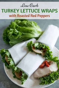 turkey lettuce wraps with roasted red peppers are on a white plate, and the wrapper is folded in half