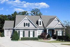 a gray house with white trim and shutters