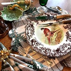 a table topped with plates and silverware on top of a wooden table