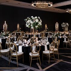 the tables are set up with black linens and gold chairs for an elegant event