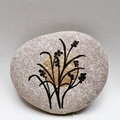 a rock with flowers painted on it