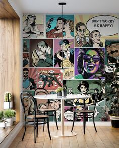 a dining room table with two chairs next to a wall covered in comic character images