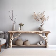 a wooden table with vases and plants on it