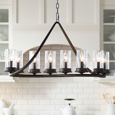 a chandelier hanging from the ceiling in a kitchen