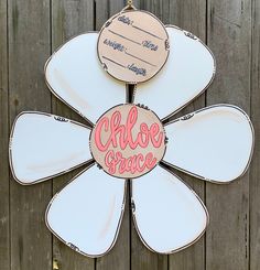 a flower shaped sign with the words choose grace on it hanging from a wooden fence