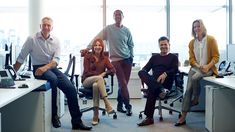 group of business people sitting at desks in an office stock photo