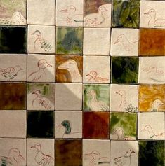 several different colored tiles with birds drawn on them