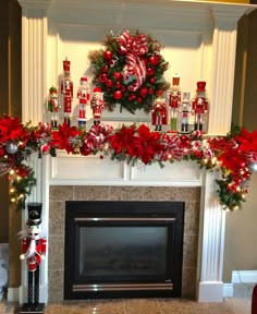 a fireplace decorated for christmas with red and green decorations