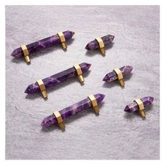 six pieces of purple stone with gold accents