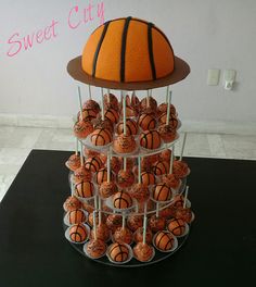 a cake made to look like a basketball ball on top of cupcakes with sprinkles