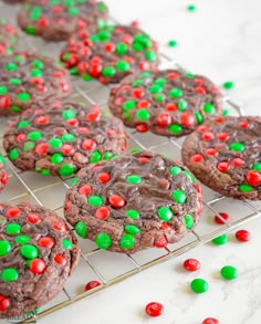 chocolate cookies with m & m candies on a cooling rack, ready to be eaten