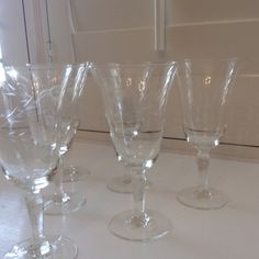 four wine glasses sitting on top of a counter