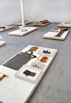 several pieces of art sit on the floor in an empty room with no one around them