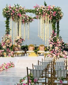 an outdoor wedding setup with chairs and flowers