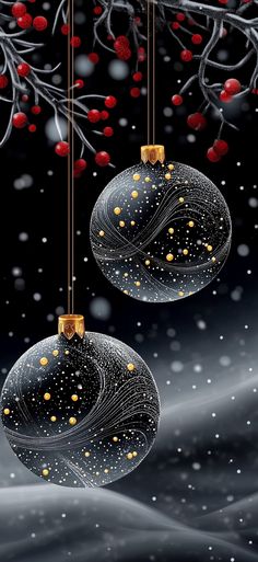 two glass ornaments hanging from a tree with red berries on it and snowing in the background