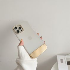 a woman is holding up her phone case