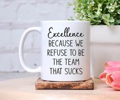 a coffee mug that says excellence because we refuse to be the team that sucks