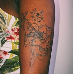 a woman's arm with a tattoo on it, which has a drawing of a girl