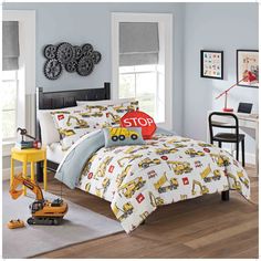 a child's bedroom with construction themed bedding