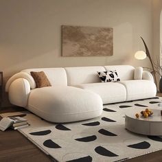 a living room with a white couch and black and white rug on the floor in front of a window