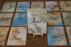 there are many maps on the table with place cards in front of them and two easers for each one