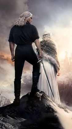 a man and woman standing on top of a mountain next to each other with swords in their hands