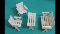 four pieces of wood sitting next to each other on a blue tablecloth covered floor