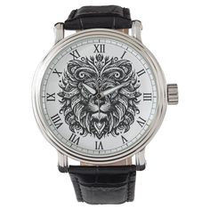 a watch with a lion head on the face and roman numerals is shown