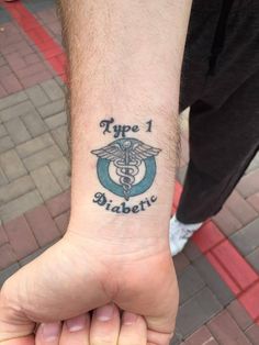 a person with a tattoo on their wrist that reads type 1 diabete and has a stethoscope