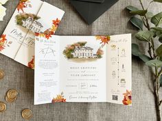 the wedding stationery is laid out on a table with flowers and coins next to it