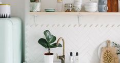 the kitchen counter is clean and ready to be used as a shelf above the sink