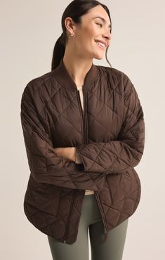 Stay warm and stylish in this oversized quilted bomber jacket, made from soft yet durable nylon taffeta fabric with a stand collar and ribbed accents. The zipper closure and patch pockets add functionality, making it a versatile choice for layering. Z SUPPLY Activewear Women's Sunrise Quilted Nylon Bomber Jacket, Coffee Bean, Extra Small Oversized Quilted Nylon Outerwear, Sporty Quilted Outerwear For Fall, Oversized Nylon Outerwear With Ribbed Cuffs, Fall Nylon Quilted Jacket, Taffeta Fabric, Short Loungewear, Knit Bottom, A Stand, Coffee Bean