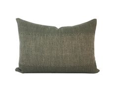 a green pillow with white stitching on the front and back, against a white background