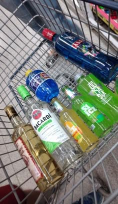 a shopping cart filled with different types of alcohol