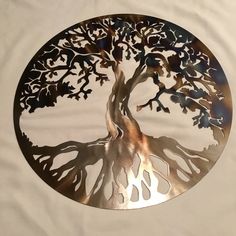 a metal tree is shown on a white sheet