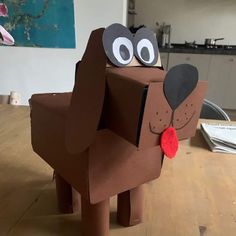 a cardboard dog sitting on top of a wooden table