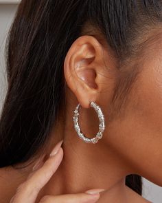 The ‘Tokyo Bamboo’ is a bamboo design inspired hoop earrings. The freeform shape of the bamboo is made possible by utilizing our Italian Electroforming production technology which also at the same time controls the weight of the earrings to maximize comfort. These hoops are made of 925 sterling silver metal plated over with 18k yellow gold or white gold. Each piece of hoops is hand polished and quality inspected to assure a high-quality finish. Closure: Hoop Stamp Approx. Measurement: Outer Length: 1.5 inches Outer Width: 5 inches Silver weight: Appox. 0.2 oz Silver Bamboo Earrings, Bamboo Hoop Earrings, Cheap Earrings, Bamboo Earrings, Bamboo Design, Earring Sale, Shop Earrings, Jewelry Pieces, Metallic Silver