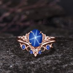 a blue stone ring sitting on top of a rock