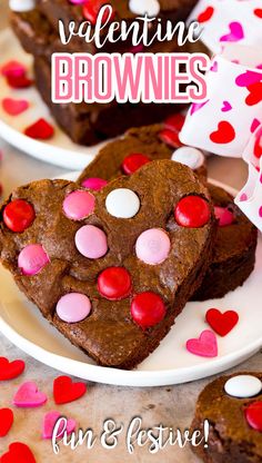 two heart shaped brownies on white plates with pink and red hearts